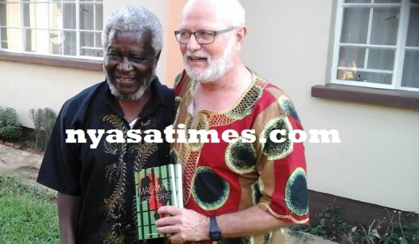 Mwakasungura and Miller showing the book