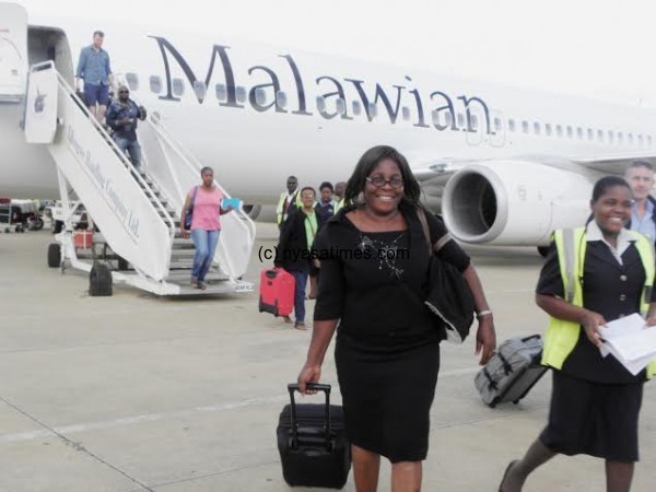 Mwandira, one of the first passengers to fly on Malawian Airlines' plane from South Africa after landing at Chileka Airport in Blantyre- Pic Lucky Mkandawire