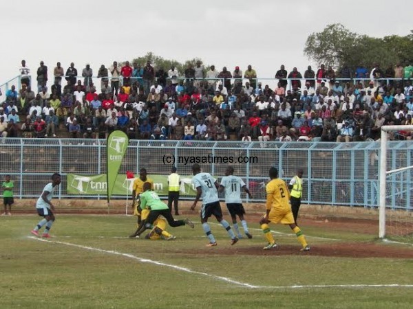 My ball! Civo goalie Duncan Mkandawire catches his defender and the ball