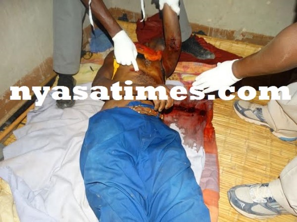 Medical personnel examining body of Mzimba murder