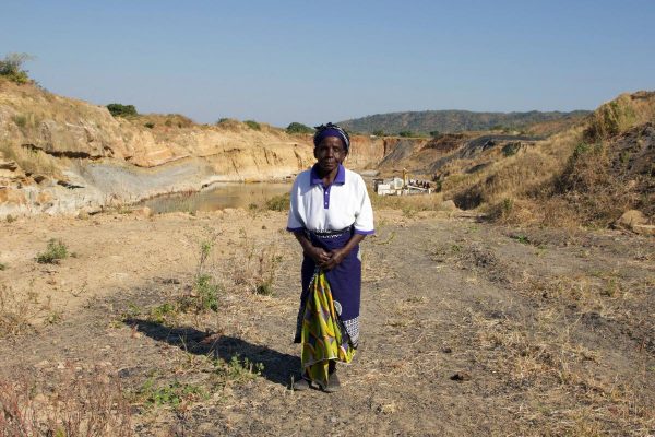 Nagomba E., 75, standing where her house used to be in Mwabulambo, Karonga district. She and her family were told to relocate in 2008 because the land was needed for coal mining.  © 2016 Lauren Clifford-Holmes for Human Rights Watch