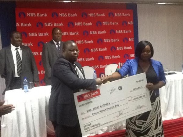 Nankhumwa handing over a K15 Million cheque to Mrs Kachala in Nyumba Yanga promotion
