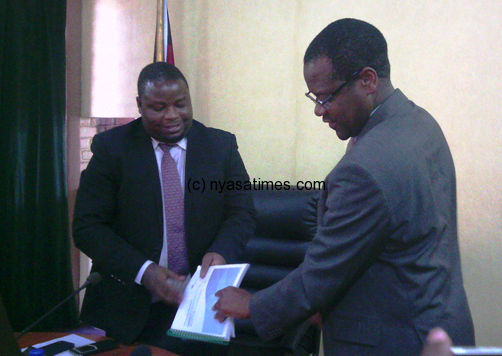 Nankhumwa (left ) Tembenu right handing over Baker Tilly Report