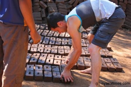 Neil George moulding bricks in Mposa, Machinga 