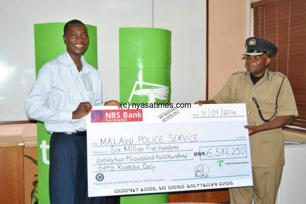 Ngwenya presents the TNM cheque to Police through commissioner Kainja