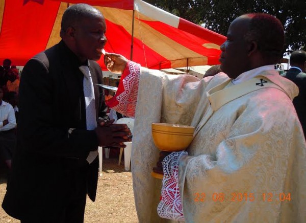 Nicholas Dausi receiving Eucharist from Archbishop Msusa....Photo Jeromy Kadewere.