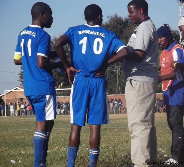 Nomads coach Stuart Mbolembole giving his players instructions. Photo by Elijah Phimbi, Nyasat Times