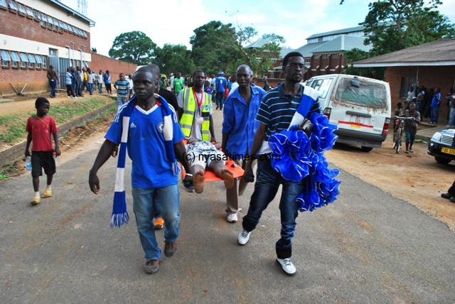 Nomads fans carried their fellow supporter on the stretcher....Photo Jeromy Kadewere