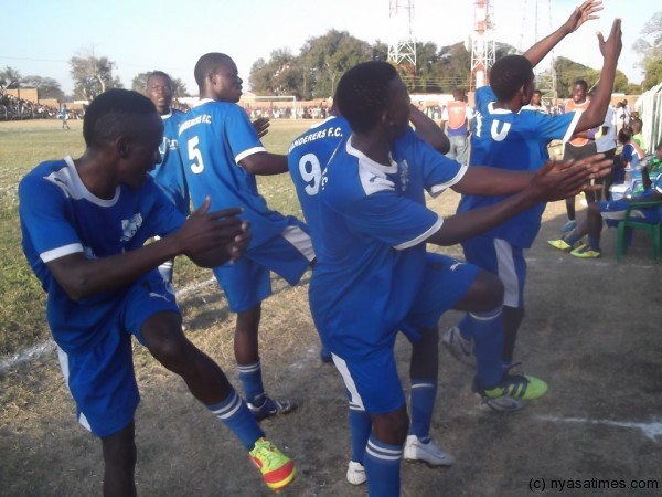 Nomads players celebrating a goal. 