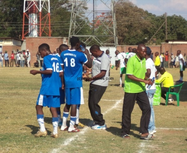 Nomads players receiving instructions from coach Mbolembole. Photo by Elijah Phimbi, Nyasa Times