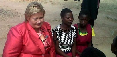 Solberg posing with Malawian girls