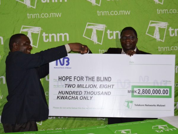 Nyirenda presenting a cheque