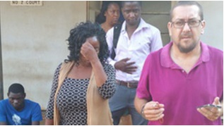 Ndovi (hiding her face) leaves Lilongwe Magistrate court with her husband (R) and other well-wishers