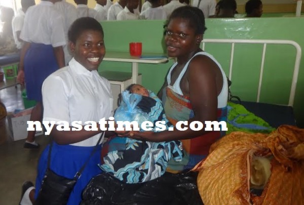 One of the Students donating to the mother of a new born baby