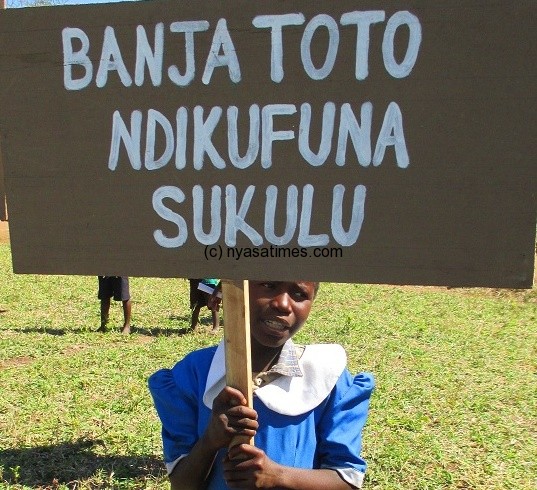 One of the girls with a placard carrying an important message....Photo Jeromy Kadewere
