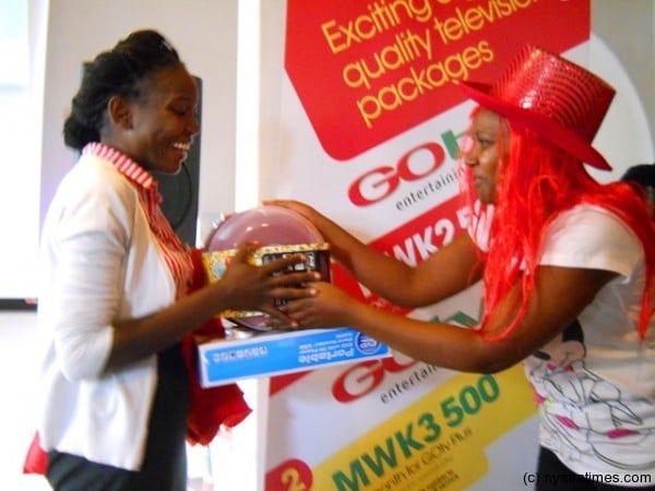 One of the journalists who won a DVD humper receiving her prize from Suzen from GOtv....Photo Jeromy Kadewere