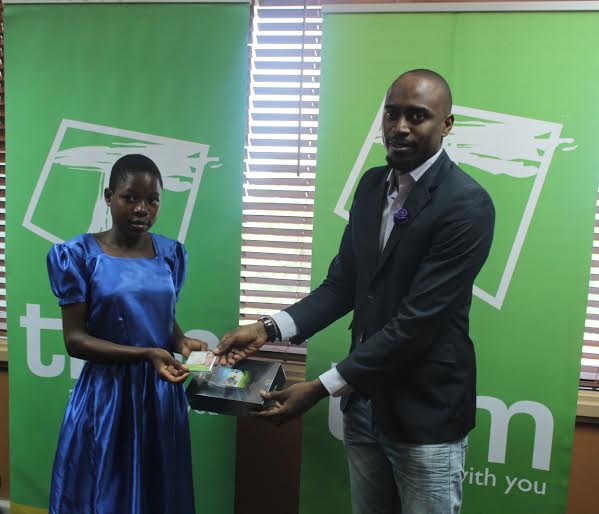 One of the winners Chifundo Magombo receiving her tablet from Jonazi