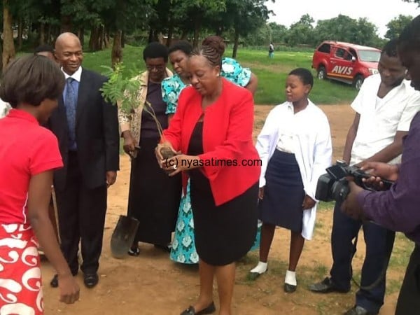 PS leads in tree planting at Mphungu School in Lilongwe at the left is Kyumba