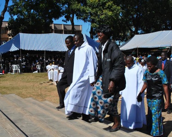 Parents escort their son to  His Grace  Msusa...Photo Jeromy Kadewere