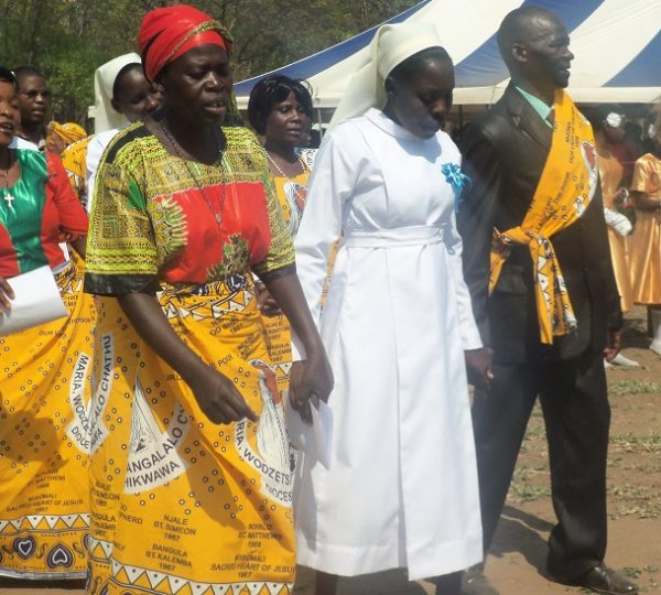 Parents giving their daughter before the alter