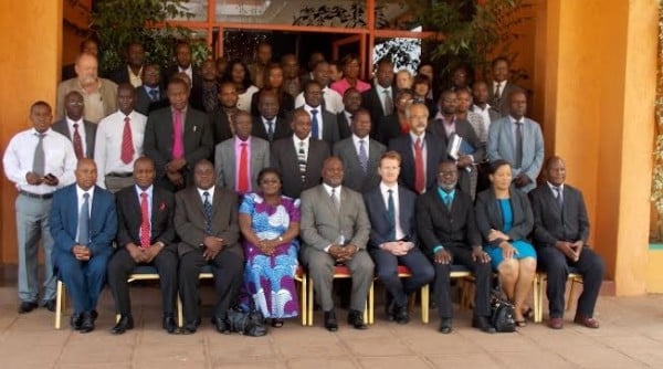 Participants pose for a group photo at the review meeting