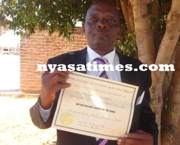 Pastor Moloseni displaying his certificate