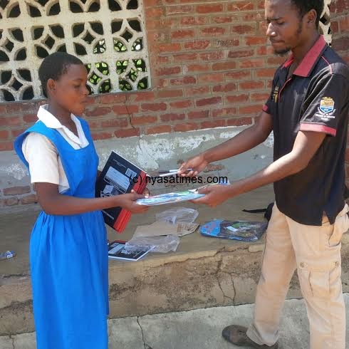 Patuma Lyson receiving the items from Amadu