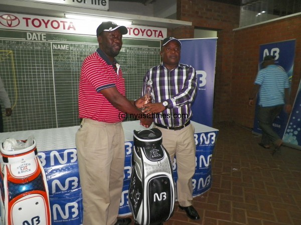 Penumlungu (left) gets his prize from National Bank 