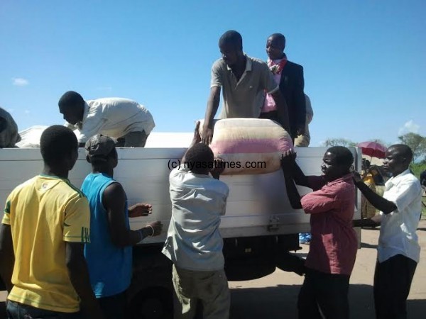 People loading maize donated by Chakwera