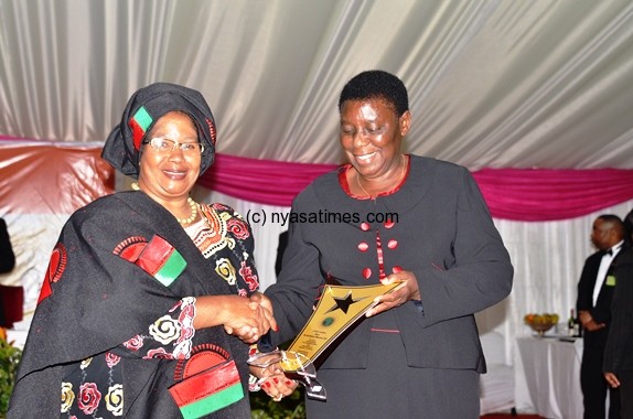 Pres Banda giving Malawi Chief Justice Msosa her award