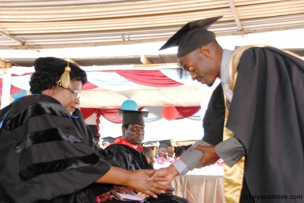 President Banda congratulates one of the graduants