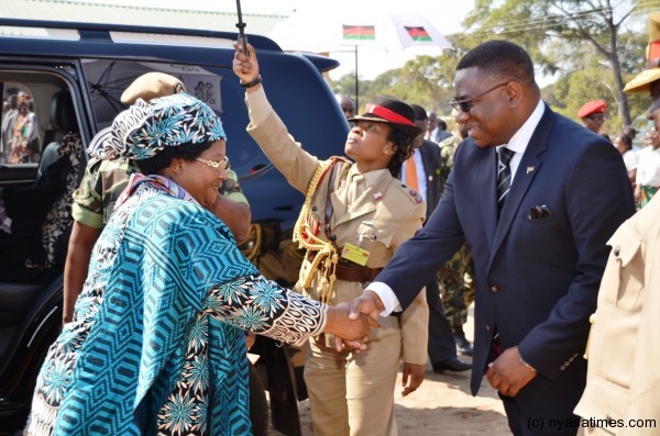 President Banda greets Lands and Housing Minister Henry Duncan Dama Phoya on arrival to hand over the houses