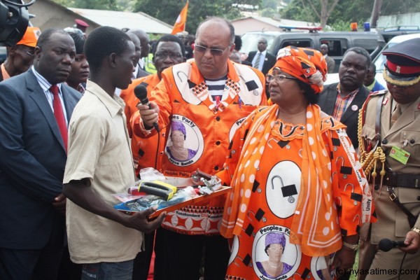 President Banda listens to one of the artisans who have benefited from the equipment