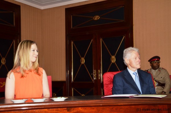 President Clinton and daughter Chelsea listen to President Banda makes her remarks