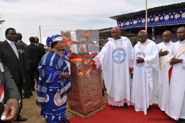 President  Banda presents a gift to Bishop Martin Mtumbuka during his priestly ordination silver jubilee