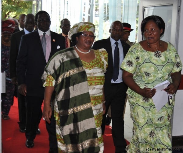 President Dr.Joyce Banda and the International Women's day committee Chairperson Regina Phanga (right) entering the COMESA hall during the celebrations.Picture by Francis Mphweya-MANA. 