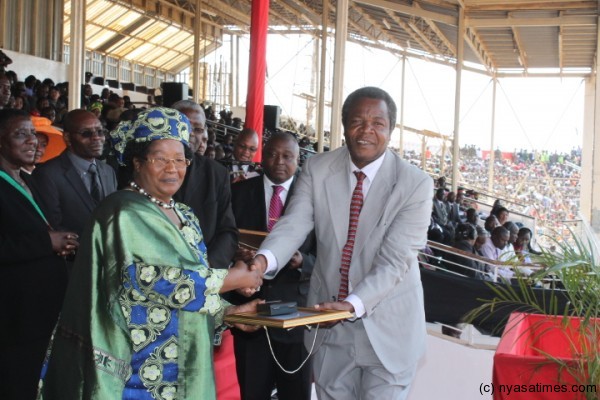 President Mrs Joyce Banda presents an award medal to Napoleon dzombe a malawian achiever to mark the 49th celecrations of independence-pic by Lisa Vintulla