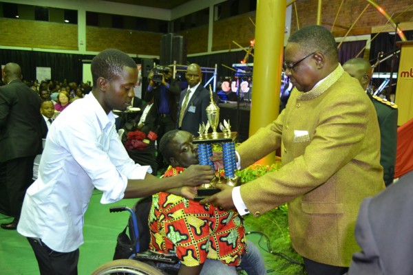 President Mutharika presents an award to the 2015 MBC to the innovator of innovators (on a wheel chair during the function.Pic Francis Mphweya-MANA