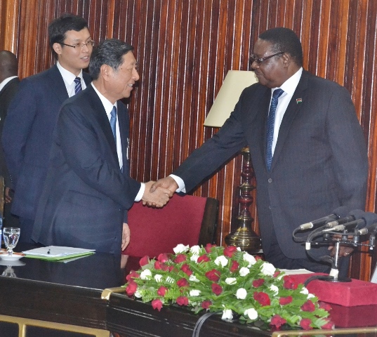 President Mutharika welcoming the Chinese leader of delegation Zhang Ping (left) at Sanjika palace in Blantyre on Sunday. Pic by Francis Mphweya