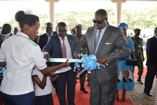 President Peter Mutharika is accompanied by the Minister of Health Dr.Peter Kumpalume cutting the ribbon to officially open Nkhatabay District Hospital (C)Stanley Makuti 