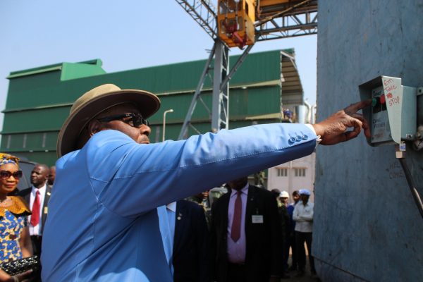 President Peter Mutharika presses a button of cane feed to kick start Saliam Sugar factory on Monday.(C)govati Nyirenda. Mana.