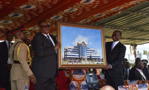 President Peter Mutharika receives a gift from the Reserve Bank Governor Charles Chuka (C)Stanley Makuti
