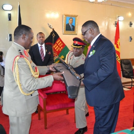 President Peter Mutharika receives a gift of Pump gun from General Ignacio Maulana Commander of MDF at Kamuzu Barracks in Lilongwe-Pic. by Abel Ikiloni
