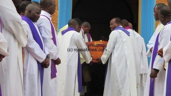Priests carrying the casket of their fallen Father-Photo by Jeromy Kadewere, Nyasa Times