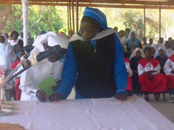 Putting her signature in the book to show acceptance