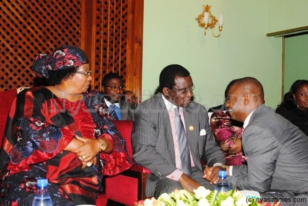 Former First Genteman,  retired  Chief Justice Richard Banda shares a joke with Walter Nyamilandu, FA Malawi president