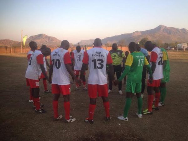 Red Lions and Civo United players pray together after the game at Zomba community centre ground