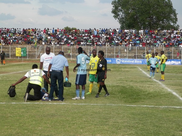 Referee Grace Msiska attends to injured Chawangangwa Kaonga, Pic Leonard Sharra, Nyasa Times