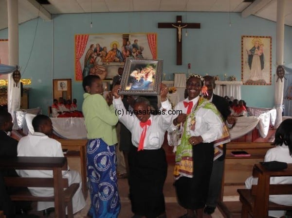Representatives of St Maria Goretti show off to the congregation their runners-up award- Pic Lucky Mkandawire