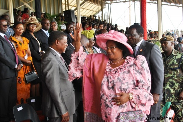 Retired Chief Justice Richard Banda (the First Gentleman)  shares light moments with Chief Justice Lovemore Munlo as President Banda waves at invited guests